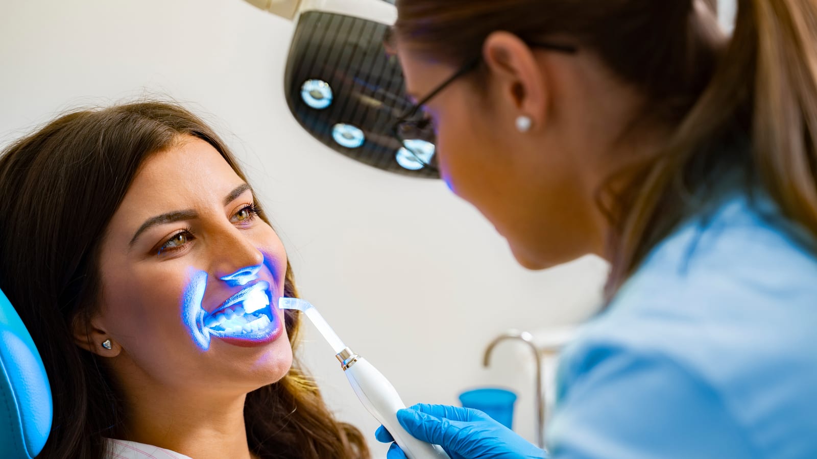 Woman undergoing teeth whitening treatment
